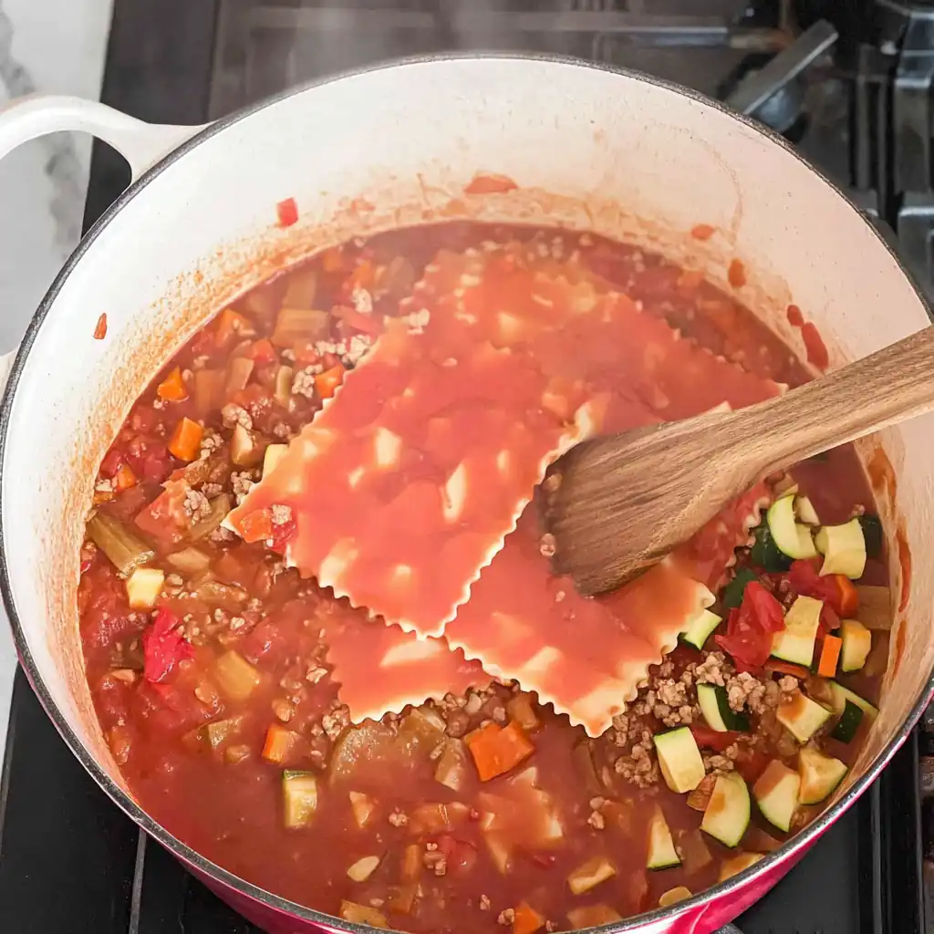 othmanrad_Dutch_oven_on_stovetop_tomato_base_simmering_sauted_75594374-86a6-42b3-90ac-f661e39ee48e_2